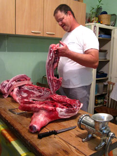 Gilles butchering the pork in his kitchen in 2010.