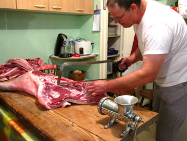 Gilles butchering the pork in his kitchen in 2010.