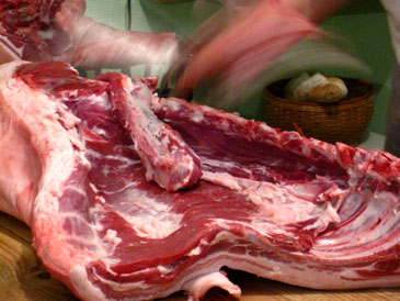 Gilles butchering the pork in his kitchen in 2010.