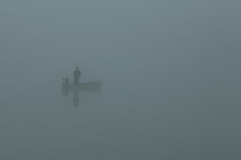 Pont-Ailler; A fisherman in the heavy fog on the River Saone.